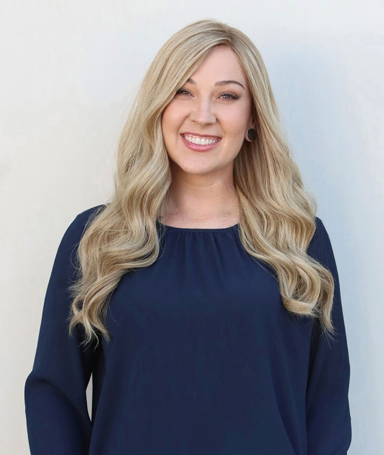 Smiling blonde woman wearing a wig