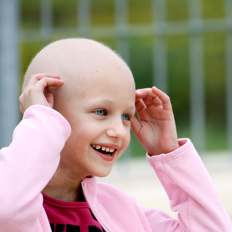 Smiling young girl without hair